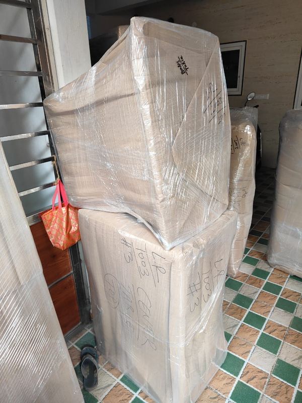 House shifting in progress with wrapped furniture