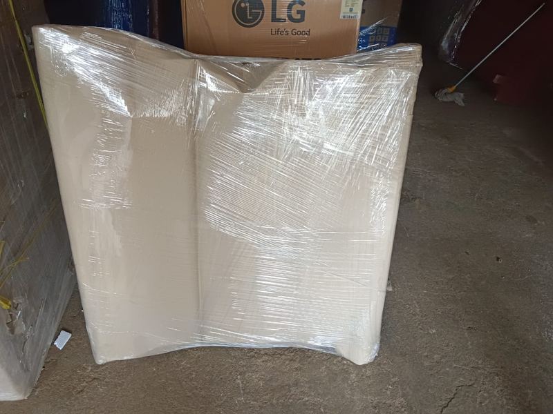 Professional packers wrapping fragile household items